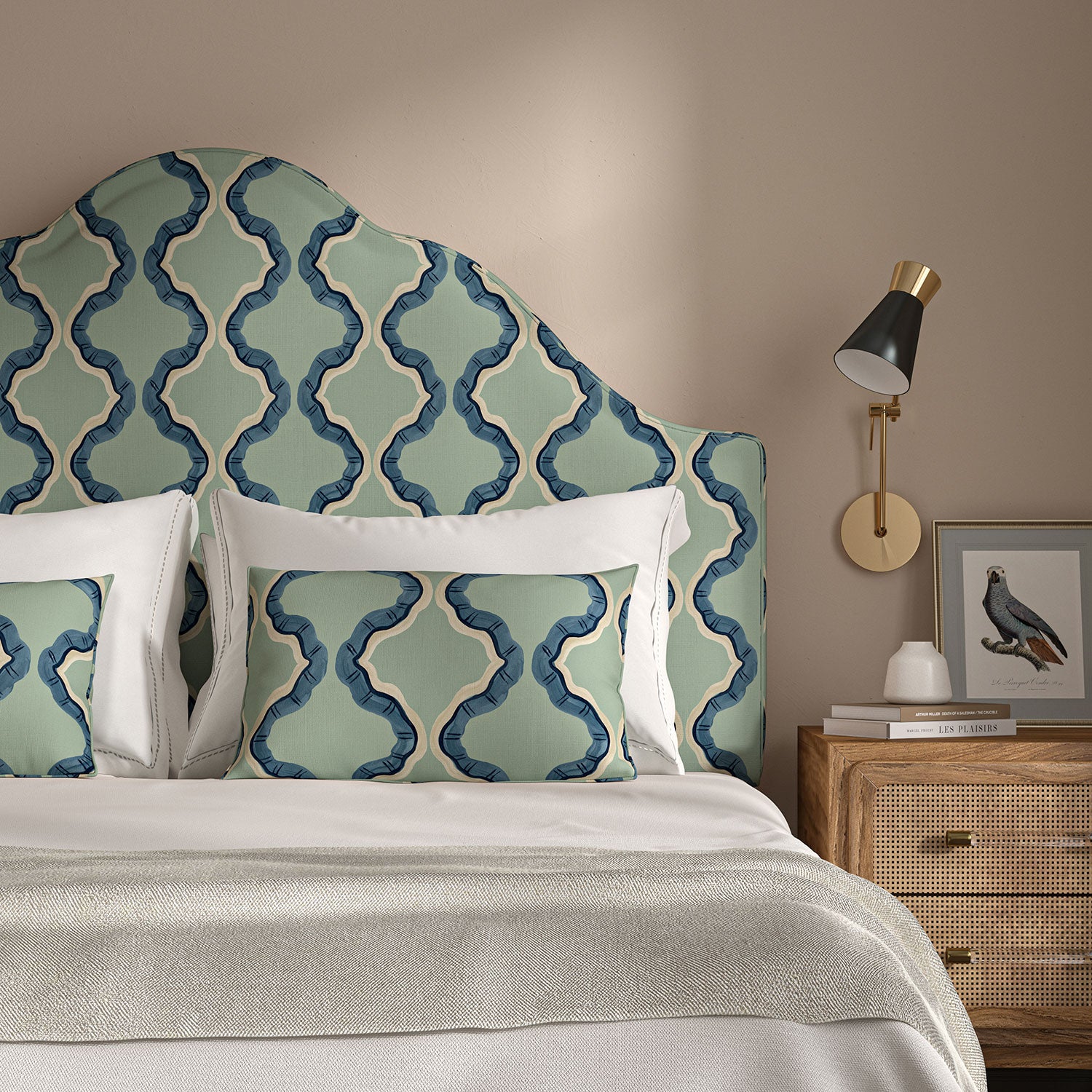 Headboard upholstered in a printed linen fabric in blue and off white featuring a mirrored ribbon pattern.