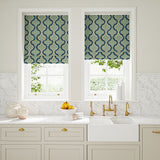 Blinds made from a printed linen fabric in blue and off white featuring a mirrored ribbon pattern.