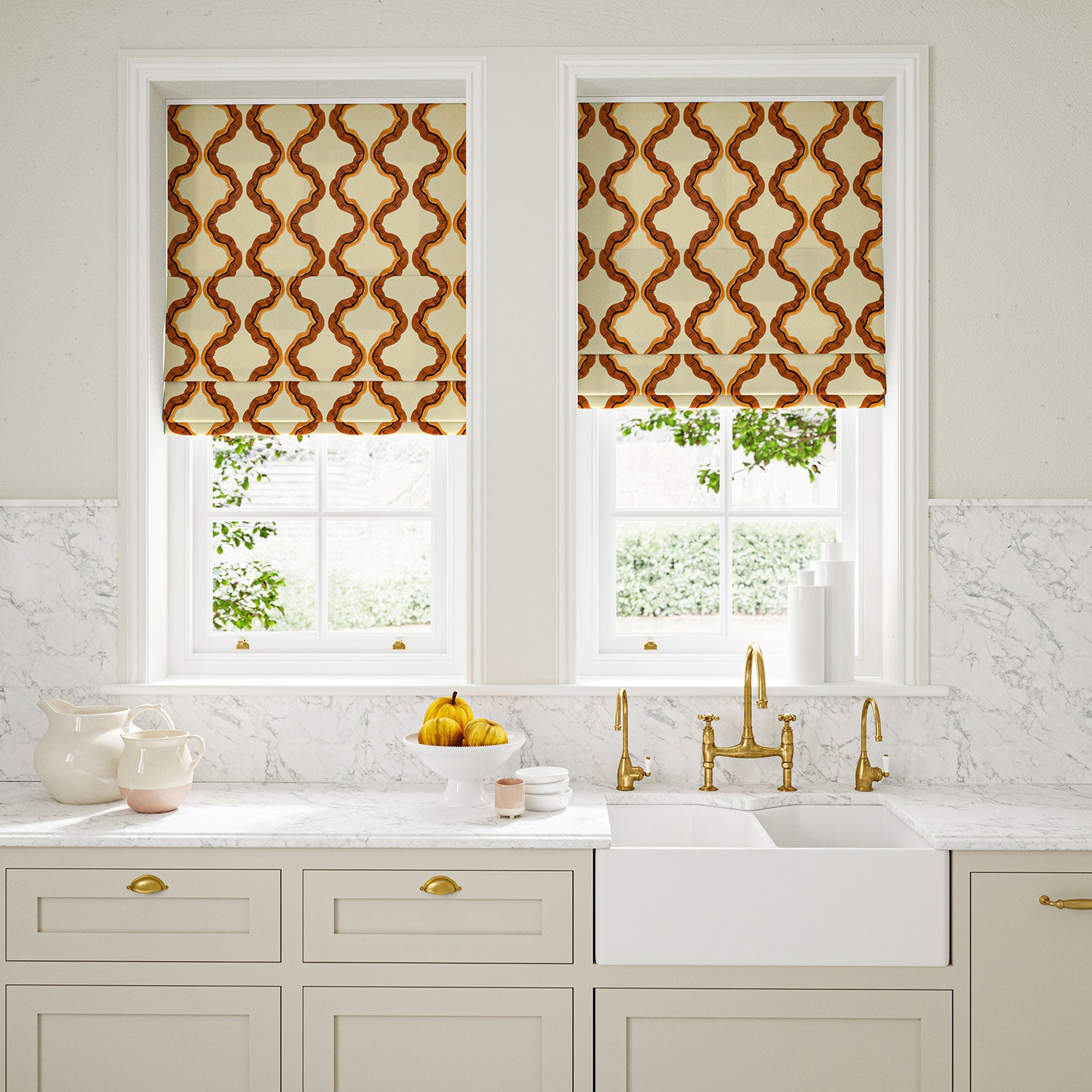 Blinds made from a printed linen fabric in blue, orange, and off white featuring a mirrored ribbon pattern.