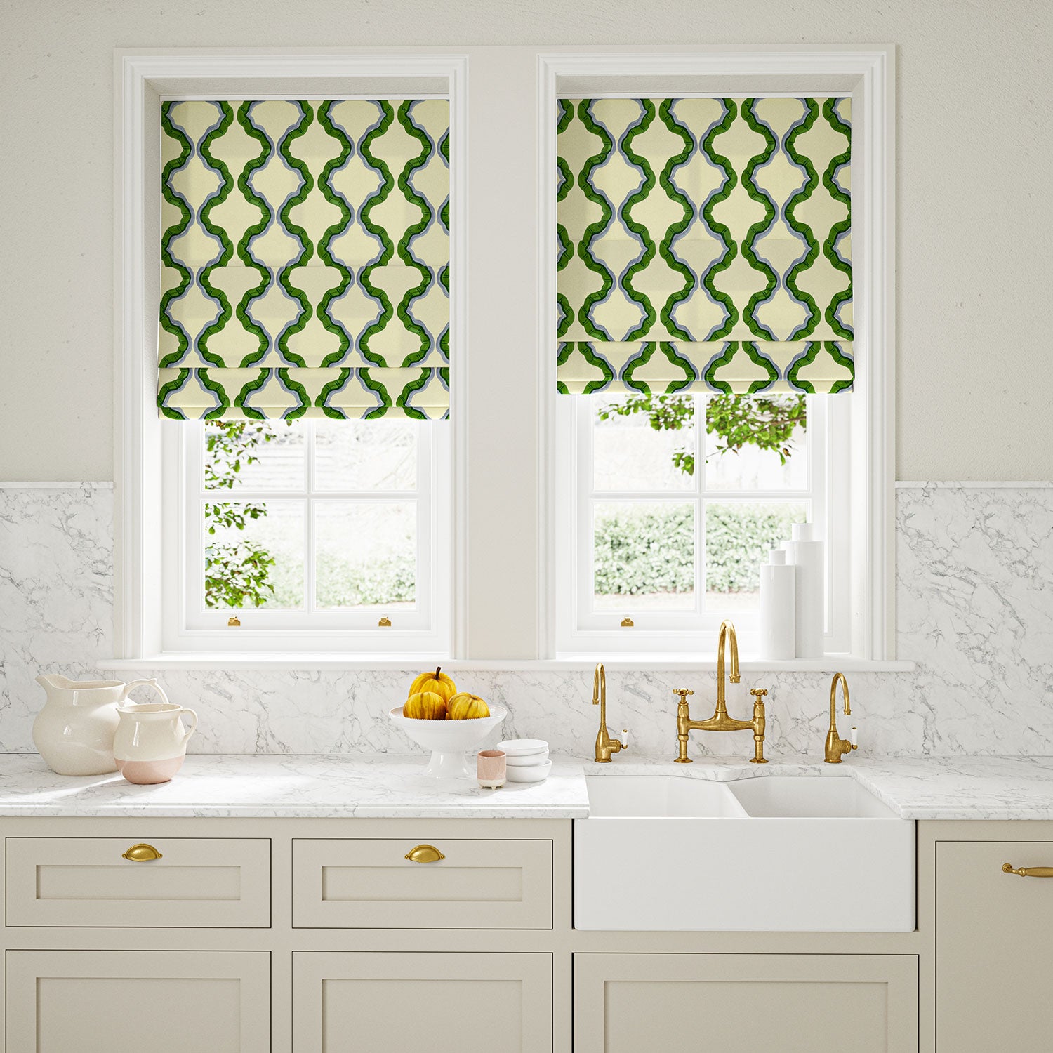 Blinds made from a printed linen fabric in green, blue, and off white featuring a mirrored ribbon pattern.