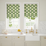 Blinds made from a printed linen fabric in green, blue, and off white featuring a mirrored ribbon pattern.