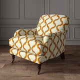 Armchair upholstered in a printed linen fabric in blue, orange, and off white featuring a mirrored ribbon pattern.