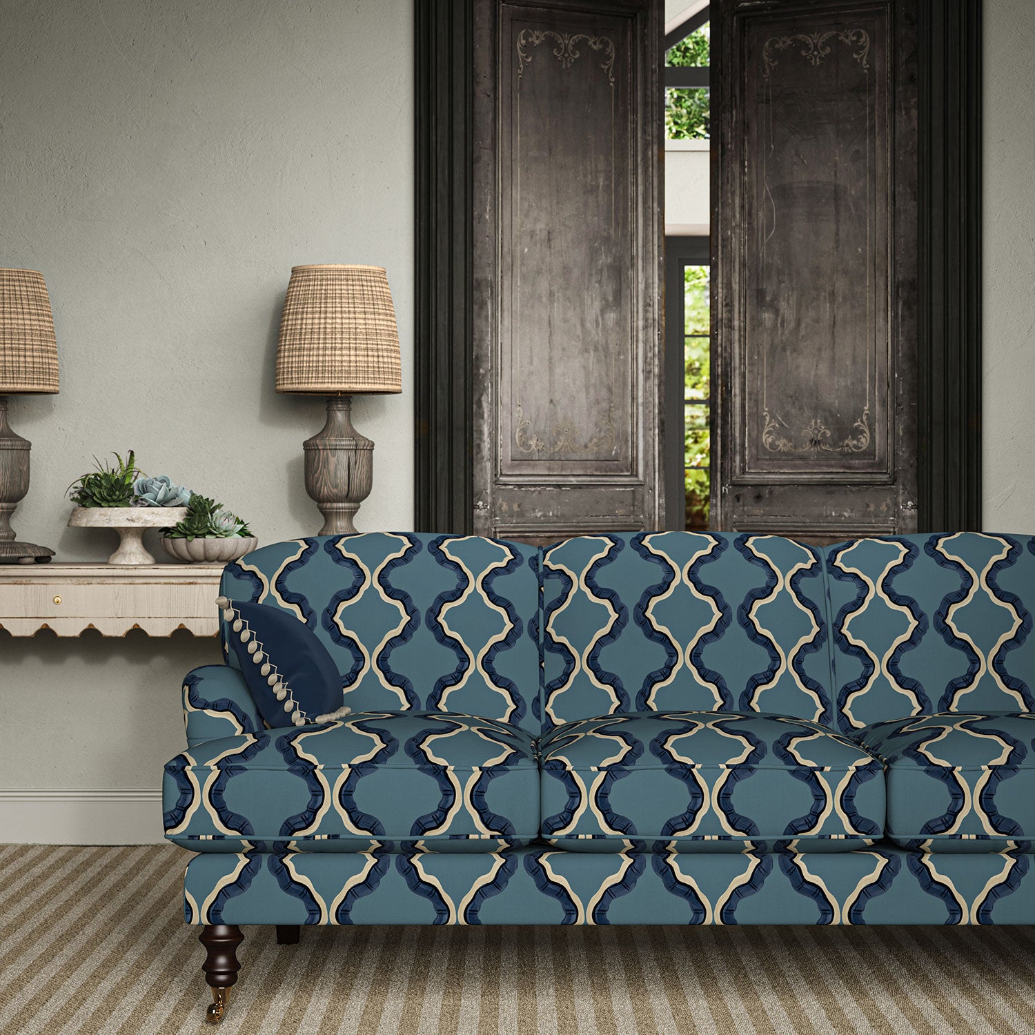 Sofa upholstered in a printed linen fabric in blue, black, and off white featuring a mirrored ribbon pattern.