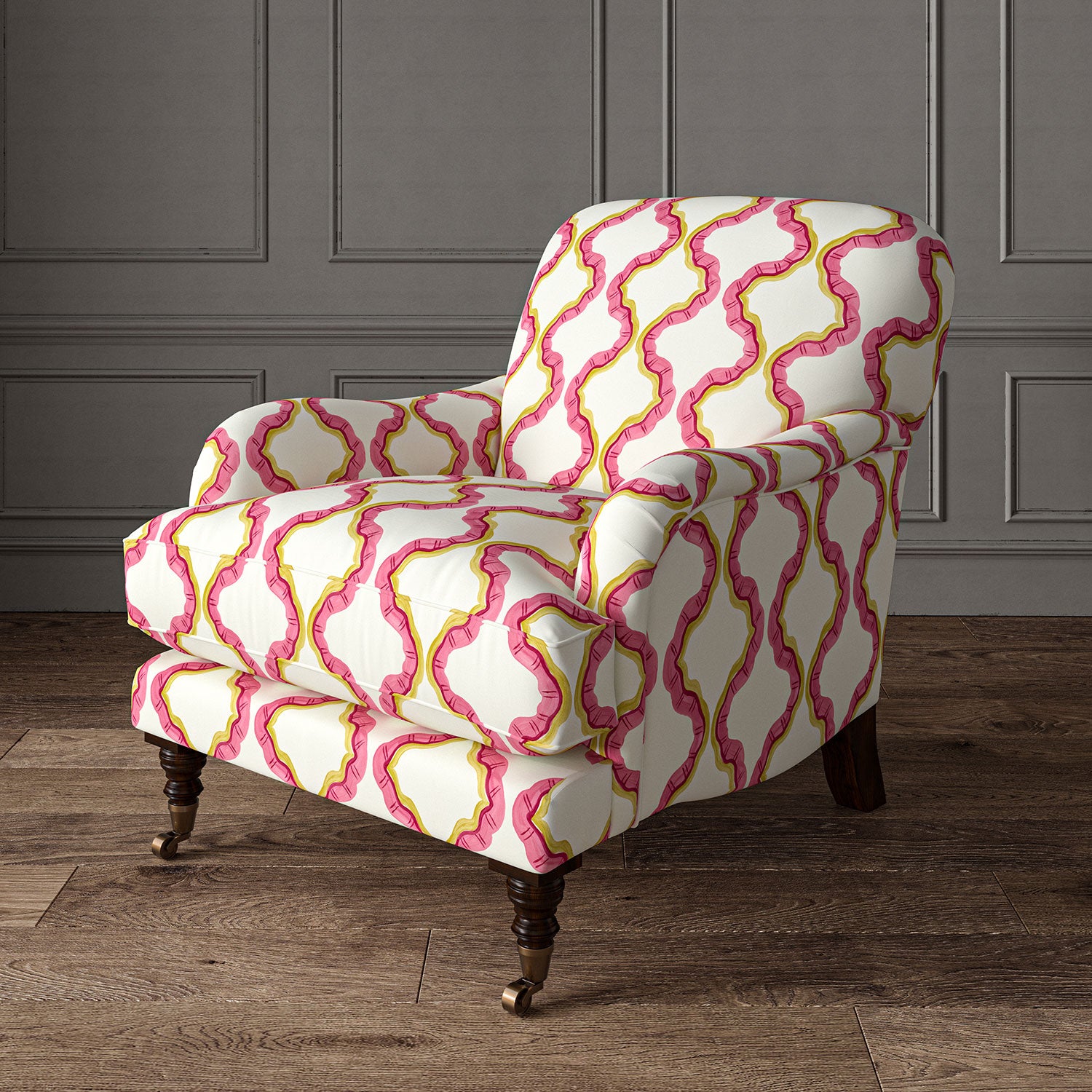 Armchair upholstered in a printed linen fabric in pink, yellow,, and off white featuring a mirrored ribbon pattern.