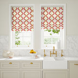 Blinds made from a printed linen fabric in pink, yellow, and off white featuring a mirrored ribbon pattern.