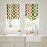 Blinds made from a printed linen fabric in pink, green, and off white featuring a mirrored ribbon pattern.