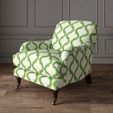 Armchair upholstered in a printed linen fabric in blue, green, and off white featuring a mirrored ribbon pattern.
