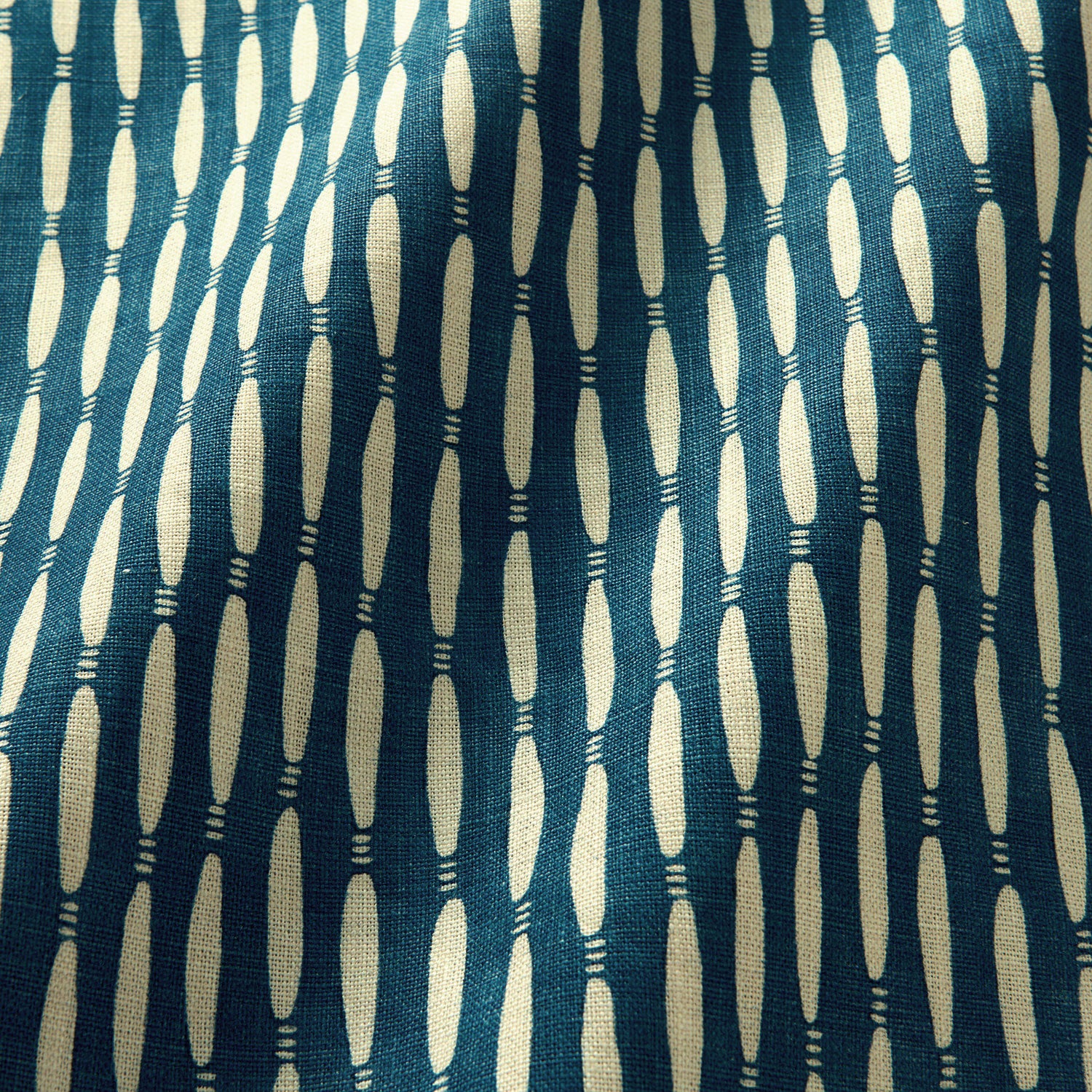 A printed linen fabric sample in blue and off white featuring a Japanese print.