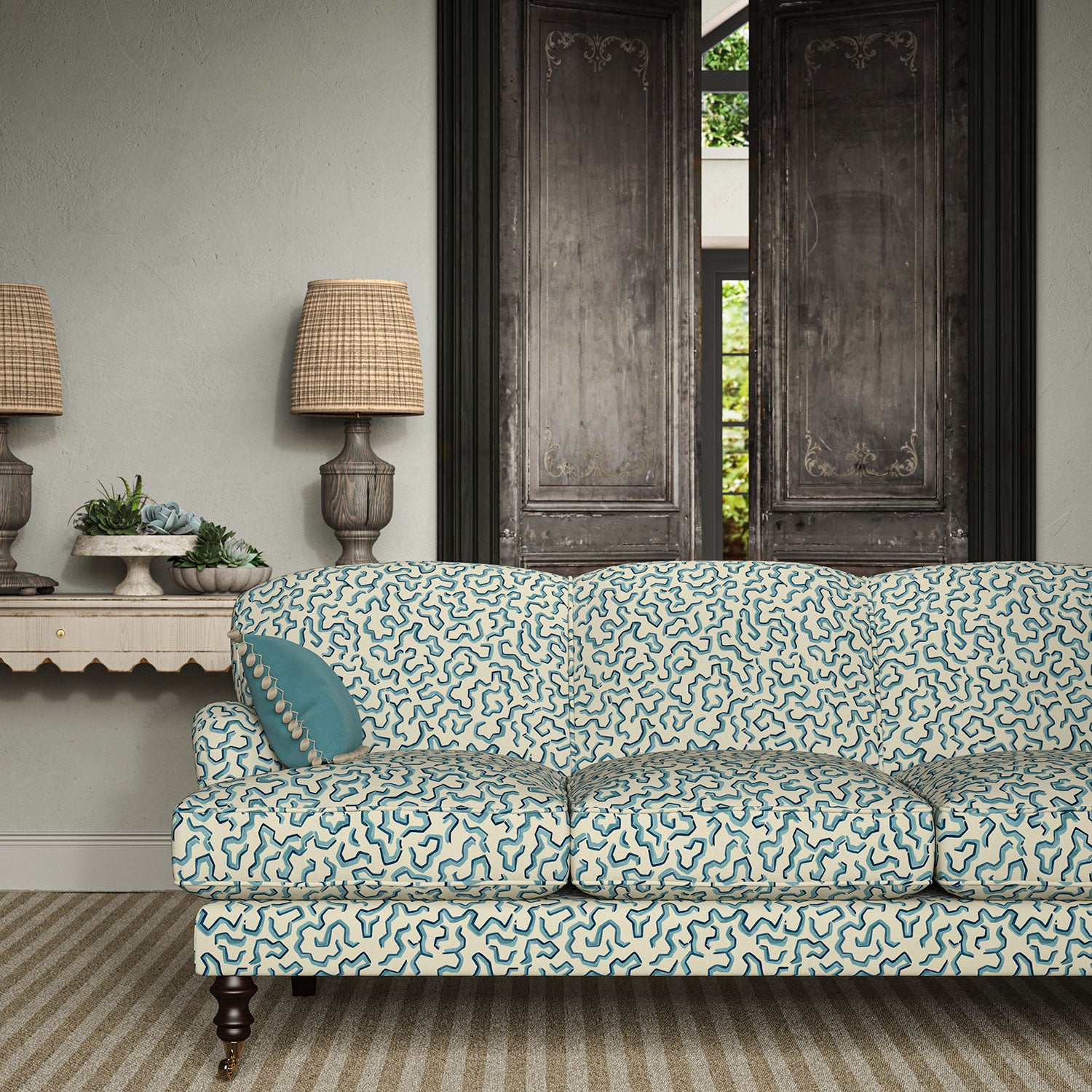 Sofa upholstered in a printed linen fabric in blue and off white featuring a feel of a classic animal print.