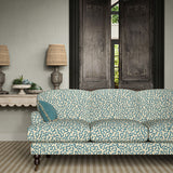 Sofa upholstered in a printed linen fabric in blue and off white featuring a feel of a classic animal print.
