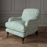 Armchair upholstered in a printed linen fabric in blue and off white featuring a feel of a classic animal print.