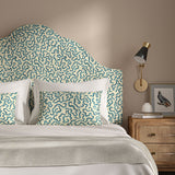Headboard upholstered in a printed linen fabric in blue and off white featuring a feel of a classic animal print.
