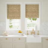 Blinds made from a printed linen fabric in brown, orange, and off white featuring a feel of a classic animal print.