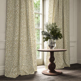 Curtains made from a printed linen fabric in brown, beige, and off white featuring a feel of a classic animal print.