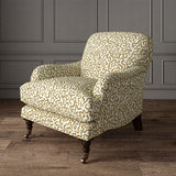 Armchair upholstered in a printed linen fabric in brown, beige, and off white featuring a feel of a classic animal print.