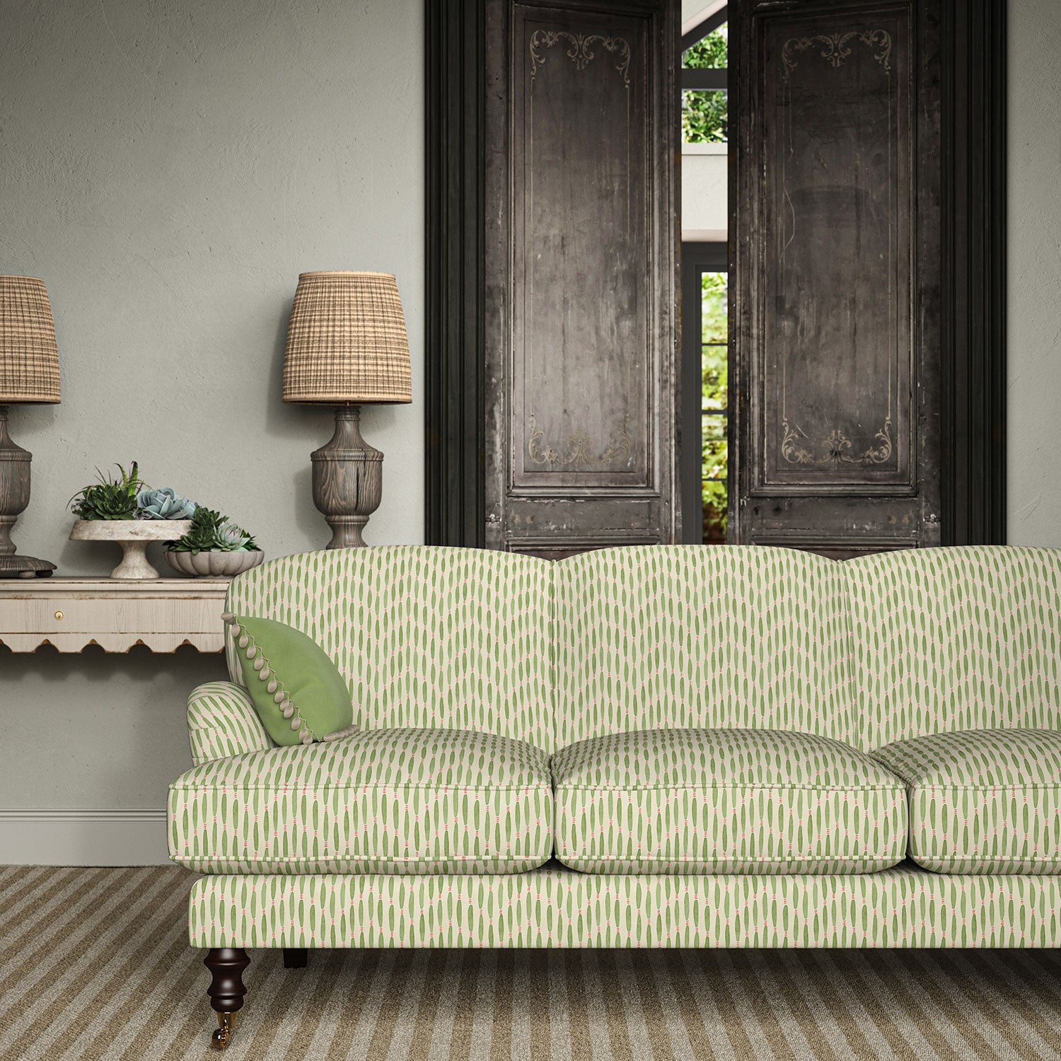 Sofa upholstered in a printed linen fabric in green, pink, and off white featuring a Japanese print.