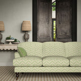 Sofa upholstered in a printed linen fabric in green, pink, and off white featuring a Japanese print.