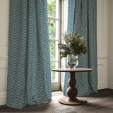 Curtains made from a printed linen fabric in blue and off white featuring a Japanese print.