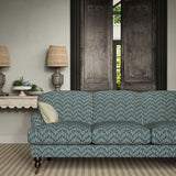 Sofa upholstered in a printed linen fabric in blue and off white featuring a Japanese print.