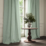 Curtains made from a printed linen fabric in blue and off white featuring a Japanese print.