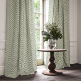Curtains made from a printed linen fabric in blue, orange, and off white featuring a Japanese print.