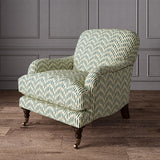 Armchair upholstered in a printed linen fabric in blue, orange, and off white featuring a Japanese print.