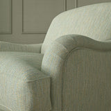 Close-up of armchair in Loxley Powder Blue by Linwood – durable, Italian-woven natural fibre fabric in muted blue.