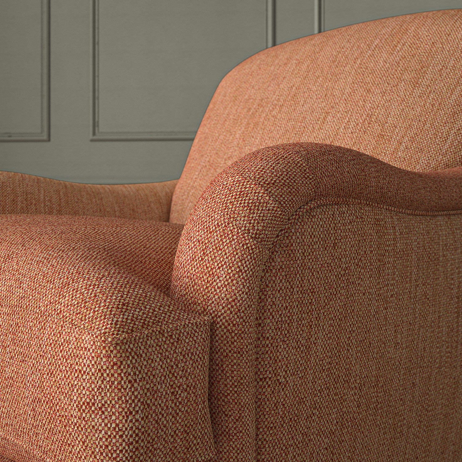 Close-up of armchair in Loxley Punch by Linwood – durable, Italian-woven natural fibre fabric in bold coral pink.