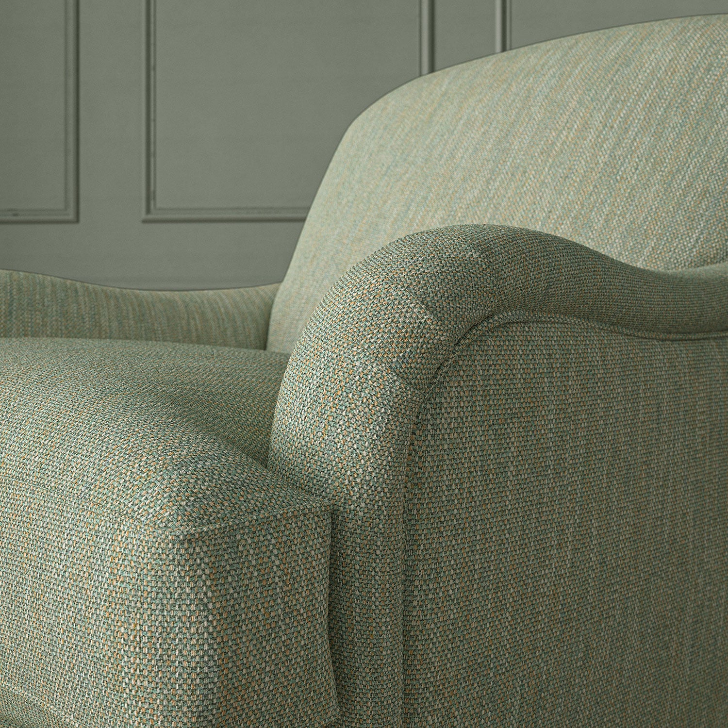 Close-up of armchair in Loxley Seagreen by Linwood – durable, Italian-woven natural fibre fabric in muted green.