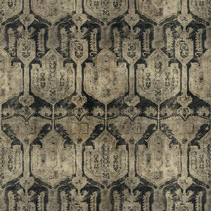 A printed velvet fabric sample in brown and black featuring a Turkish kilim pattern.