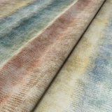 A multicoloured printed velvet fabric sample featuring pastel stripes.