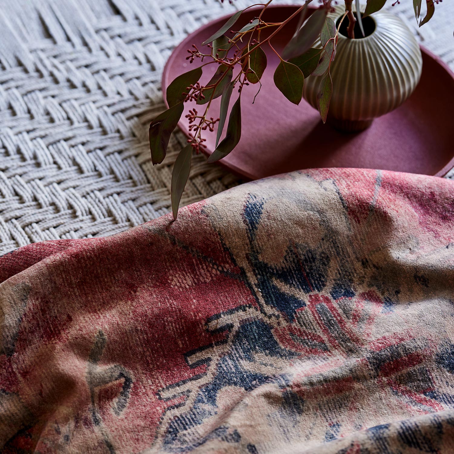 A printed velvet fabric sample in red with the feel of a vintage rug.