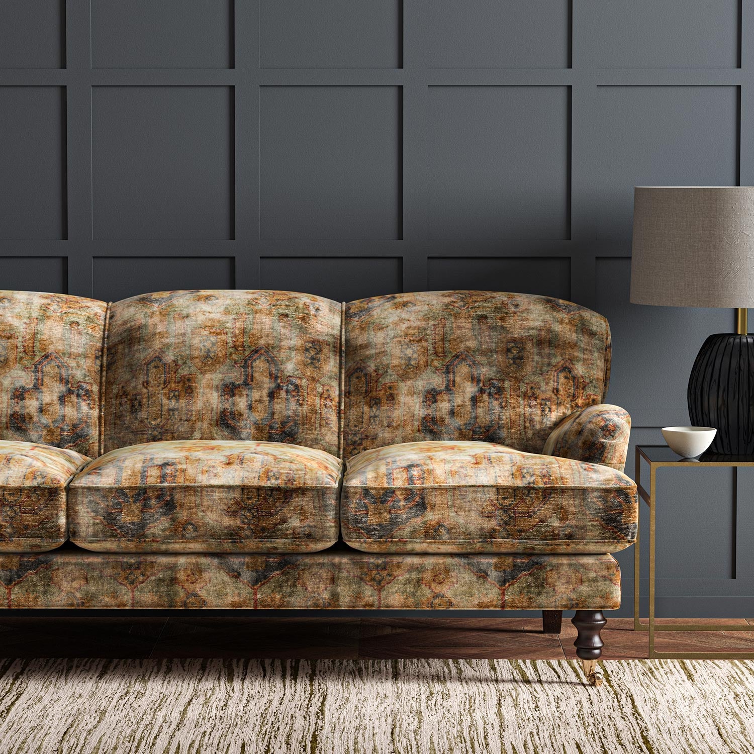 Sofa upholstered in a printed velvet fabric in brown and black featuring an opulent pattern.