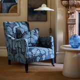 Armchair upholstered in a woven velvet in blue and cream featuring two birds.