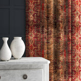 Curtains made from a printed velvet fabric in red and brown featuring a stripe kilim pattern.