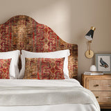 Headboard upholstered in a printed velvet fabric in red and brown featuring a stripe kilim pattern.