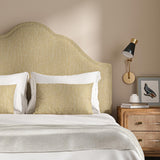 Headboard upholstered in a plain luxurious woven fabric in yellow.