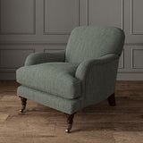 Chair upholstered in a plain luxurious woven fabric in blue.