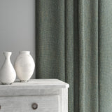 Curtain made from a plain luxurious woven fabric in blue.