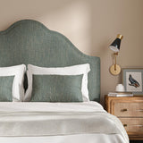 Headboard upholstered in a plain luxurious woven fabric in blue.