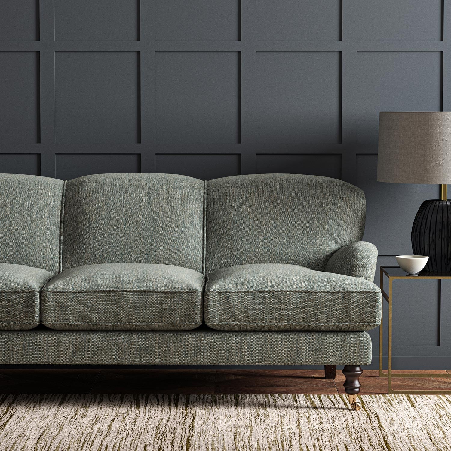 Sofa upholstered in a plain luxurious woven fabric in blue.