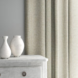 Curtain made from a plain luxurious woven fabric in cream.