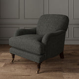 Chair upholstered in a plain luxurious woven fabric in grey.