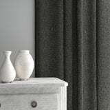 Curtain made from a plain luxurious woven fabric in grey.