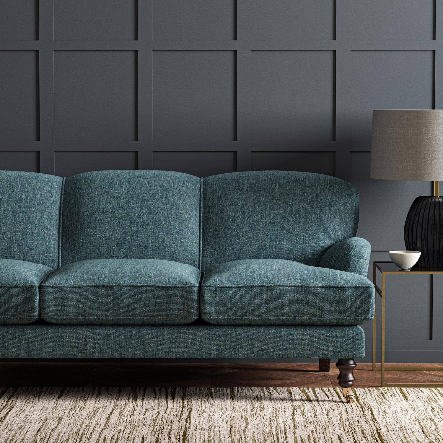 Sofa upholstered in a plain luxurious woven fabric in blue.