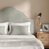 Headboard upholstered in a plain luxurious woven fabric in grey.