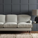 Sofa upholstered in a plain luxurious woven fabric in grey.