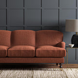 Sofa upholstered in a plain luxurious woven fabric in red.