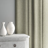 Curtain made from a plain luxurious woven fabric in cream.