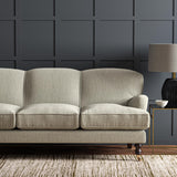 Sofa upholstered in a plain luxurious woven fabric in cream.